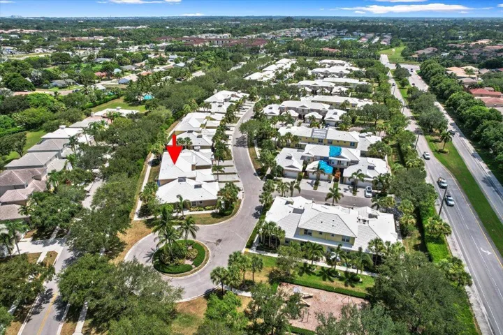 Aerial view highlighting the townhome's setting and nearby residential streets.