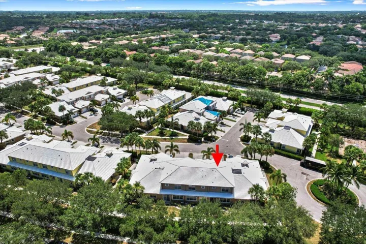 Wide aerial view of the neighborhood featuring residential streets and nearby green spaces.