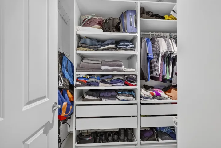 Full walk-in closet with pull out closets.