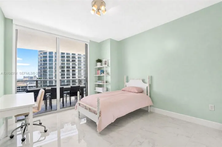 Floor-to-ceiling sliding glass doors, polished stone-finish flooring, and built-in shelving