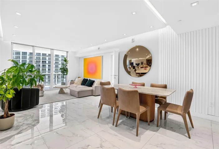 Large-format tile flooring, vertical wall paneling, recessed lighting, and floor-to-ceiling glass windows