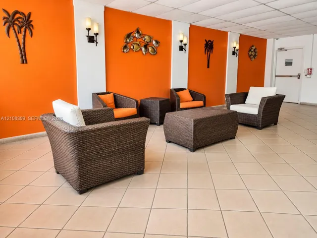 Common area featuring ceramic tile flooring, neutral wall accents, and wall-mounted light fixtures
