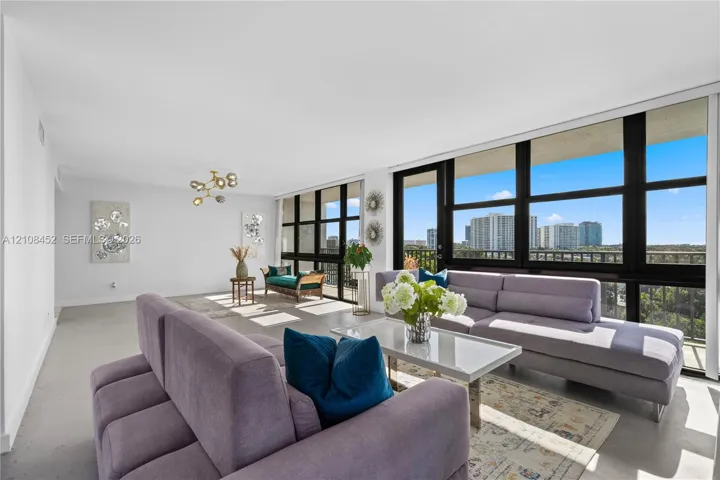 Floor-to-ceiling windows, polished concrete flooring, multi-arm flush-mount lighting, and integrated exterior balcony access