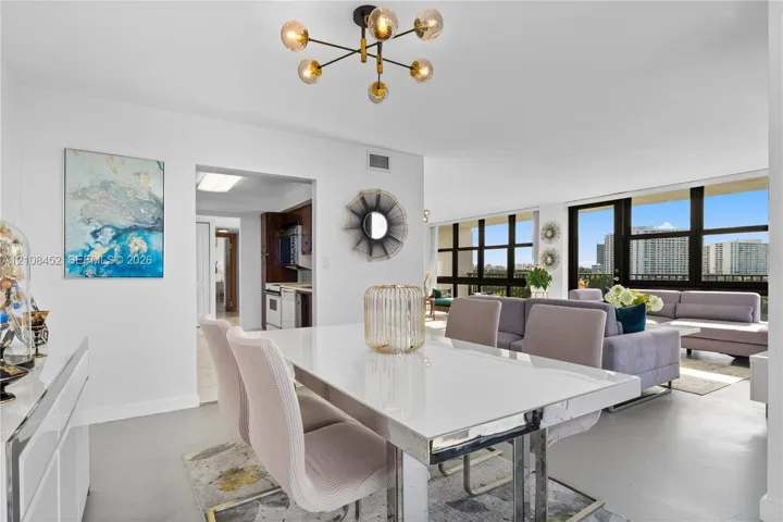 Modern multi-arm sputnik chandelier, floor-to-ceiling windows with external terrace access, and smooth-finish flooring