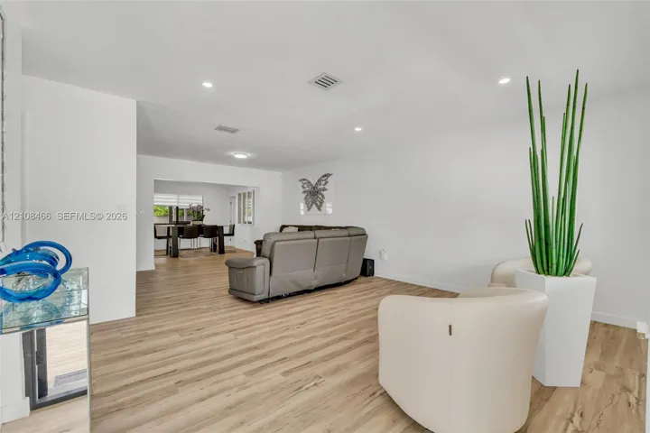 Open-concept interior featuring light wood-finish flooring and recessed lighting