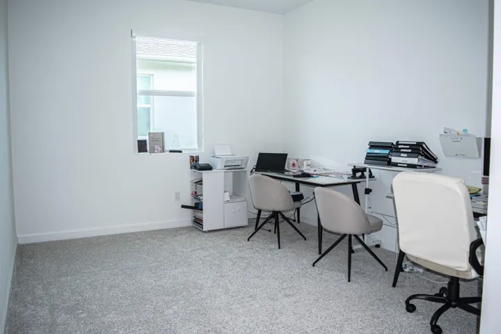 Neutral interior room featuring neutral carpeting and a single pane window