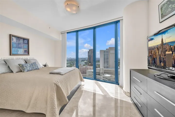 Floor-to-ceiling windows, polished stone flooring, and rounded structural column