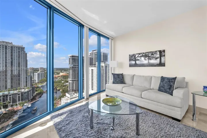 Floor-to-ceiling windows featuring panoramic urban scenery and stone-finish flooring