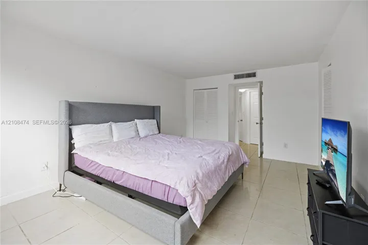 Neutral-toned tile flooring, white wall finishes, and bi-fold closet​​‌​​​​‌​​‌‌​‌‌​​​‌‌​‌​‌​‌​​​‌​​ doors