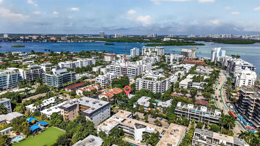 Aerial perspective of the property location, characterized by mature tropical landscaping, dense residential density, and proximity to coastal waters