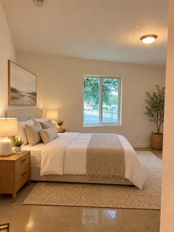 Vaulted ceiling, neutral wall tones, single-pane window, and polished concrete flooring