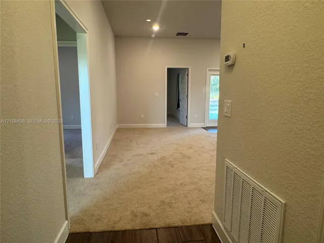 Neutral wall tones, carpeted flooring, recessed lighting, and interior passage doors