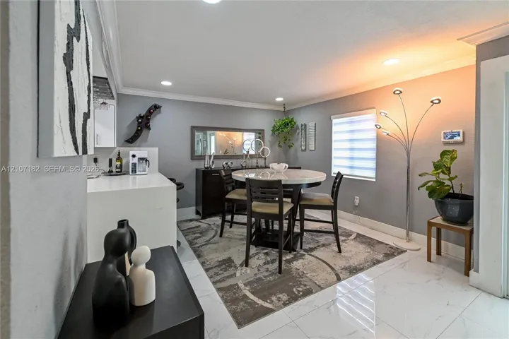 Recessed ceiling lighting, large-format tile flooring, and solid-surface countertop