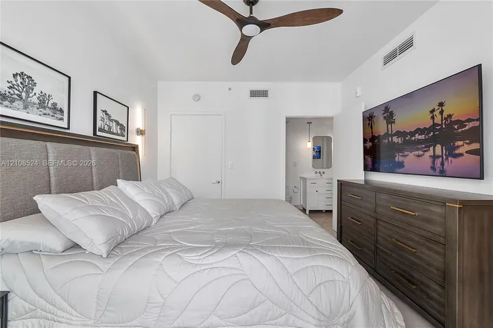 Three-blade ceiling fan, wall-mounted vertical light fixture, and recessed lighting