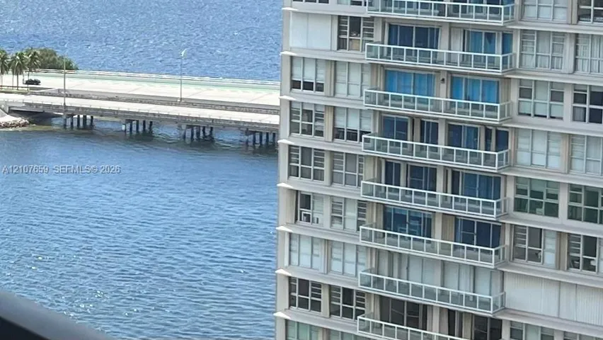 High-rise exterior featuring multiple levels of cantilevered balconies with glass railings and floor-to-ceiling windows