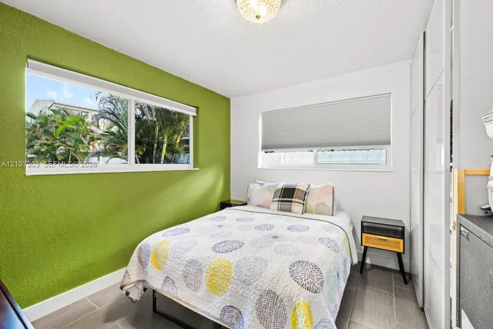 Dual-pane windows, built-in floor-to-ceiling cabinetry, tile flooring, and a flush-mount ceiling light fixture