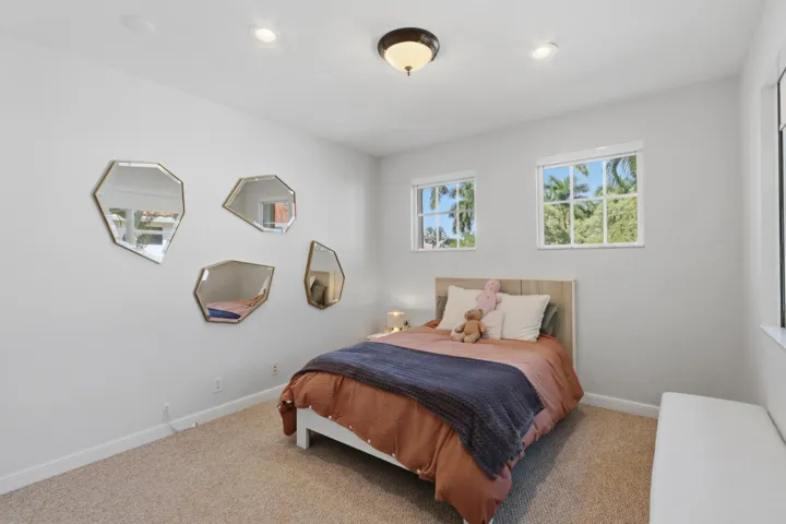 Neutral-toned interior featuring wall-to-wall carpeting, multi-pane windows, and recessed lighting