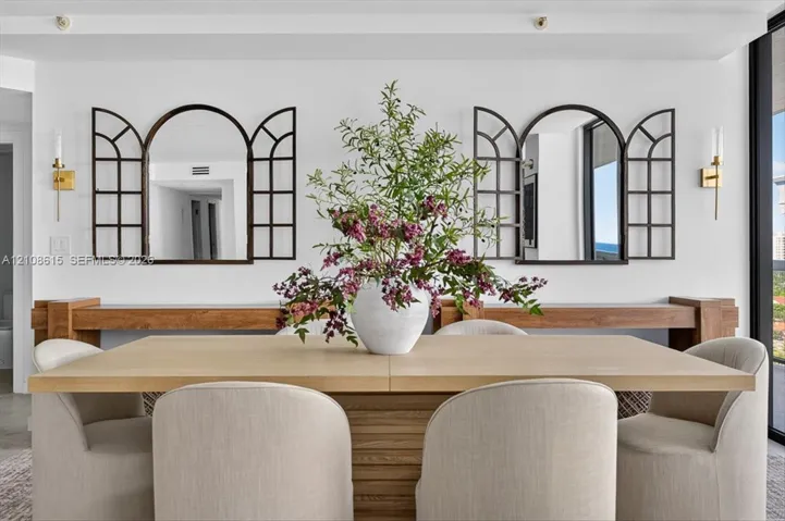 Custom wood wall-mounted consoles with two arched window-pane style decorative mirrors and dual metallic wall-mounted light fixtures