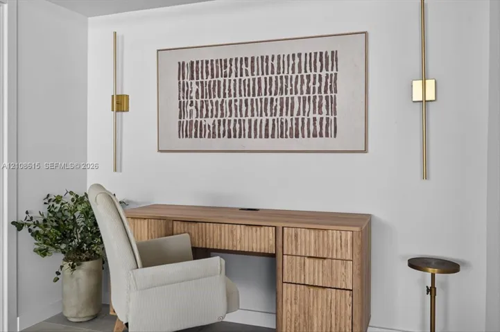 Vertical brass wall-mounted light fixtures with a minimalist aesthetic