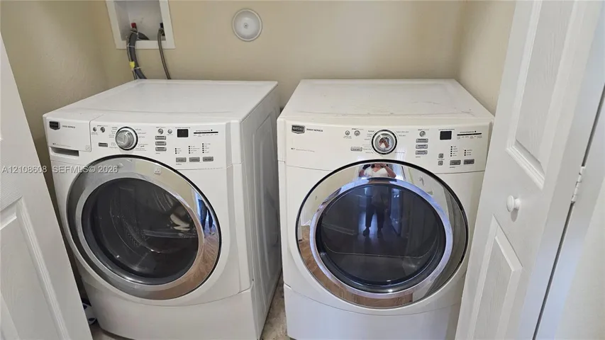Dedicated laundry alcove equipped with wall-mounted water supply lines and recessed connections