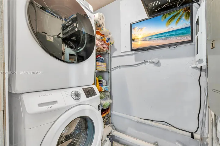 Stacked front-load laundry unit featuring a white finish