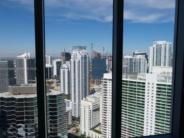 Floor-to-ceiling windows featuring expansive urban skyline exposure