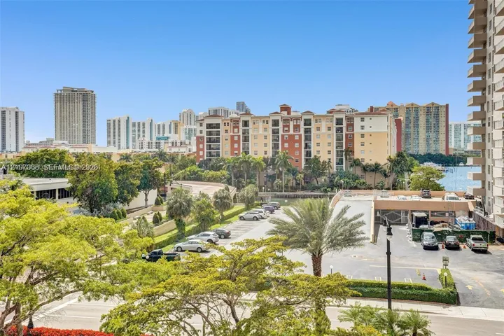 Elevated perspective featuring mature palms, manicured landscaping, and expansive urban scenery