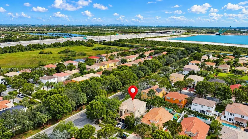 Aerial perspective featuring a two-story residential structure with a hipped tile roof and paved driveway