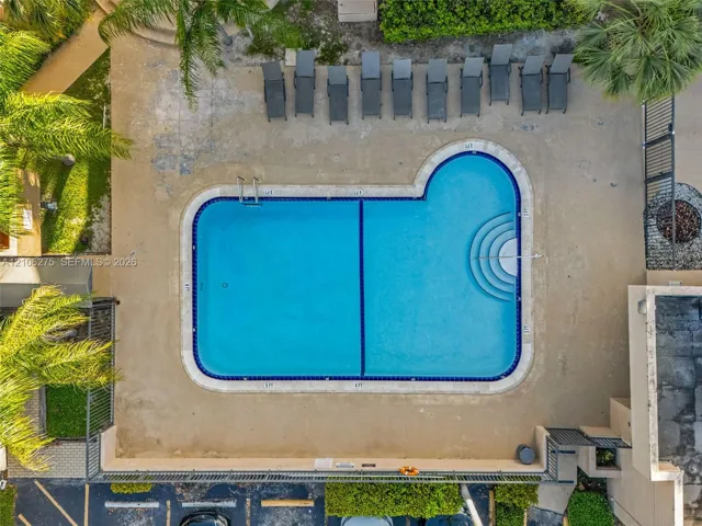 Swimming pool with a dual-depth floor, integrated tiled steps, and a concrete deck surround