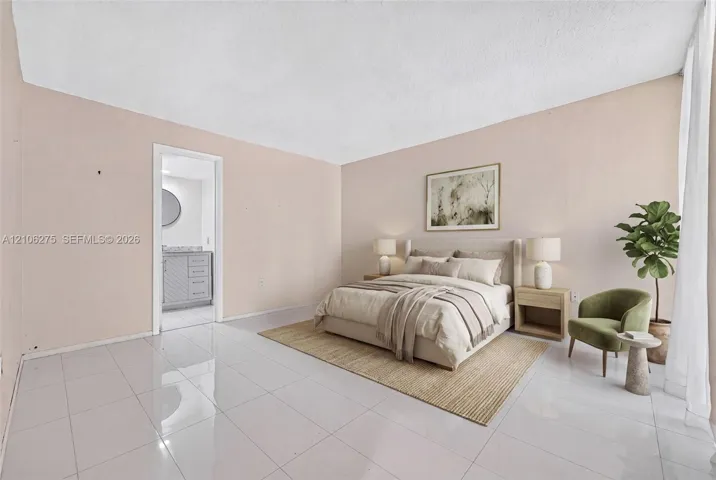 Large-format tile flooring and neutral wall color palette with direct entry to a private bathroom