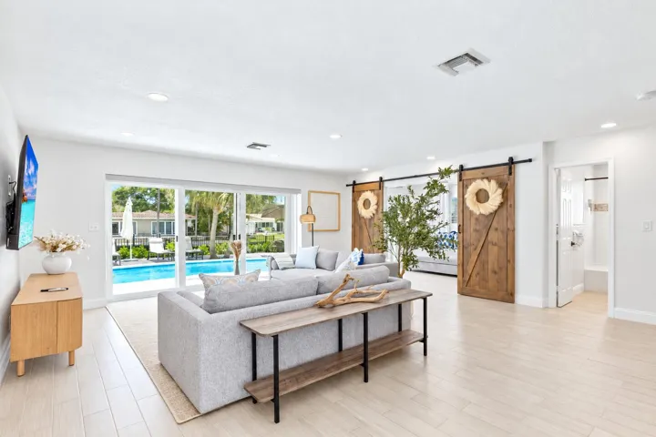 Bright Coastal Living Room with Pool Vie