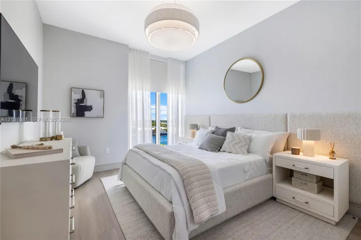 Bedroom featuring wood-finish flooring, floor-to-ceiling windows, a textured fabric headboard wall panel, and a contemporary tiered drum pendant light
