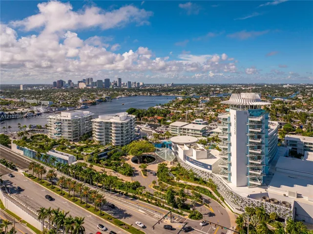 Aerial perspective featuring mid-rise coastal architecture, expansive landscaped grounds, integrated hardscaping, and proximity to the Intracoastal Waterway