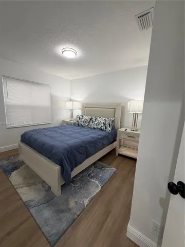 Wood-finish flooring, neutral wall tones, and recessed ceiling lighting