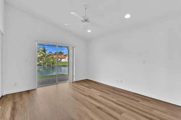 Primary Bedroom with vaulted ceilings, brand new luxury vinyl plank and freshly painted