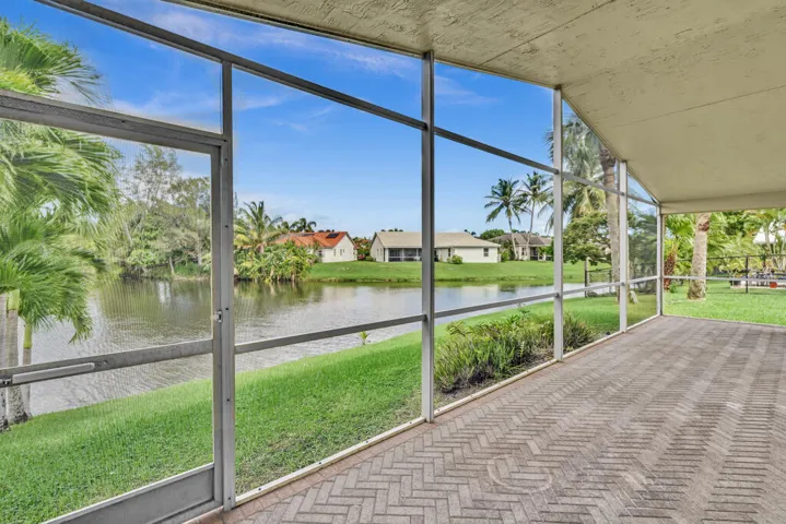 Oversized screened in patio with vaulted ceilings overlooking the water