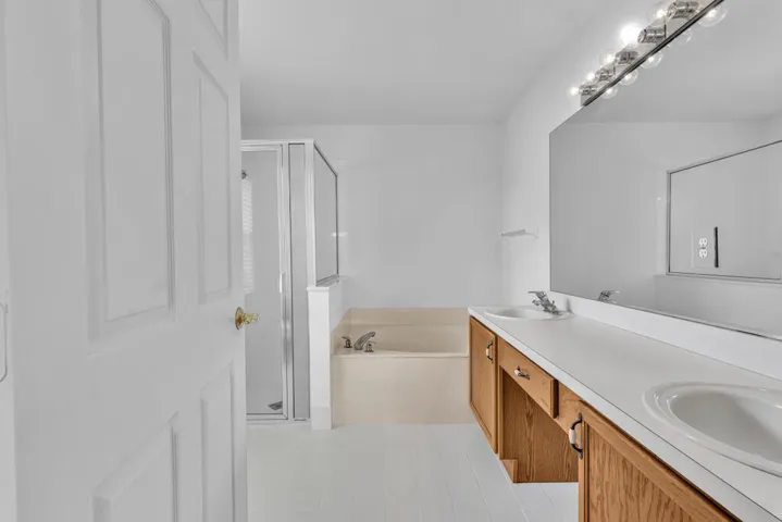 Primary Bathroom with Dual Vanity Sinks & Separate Shower & Roman Tub
