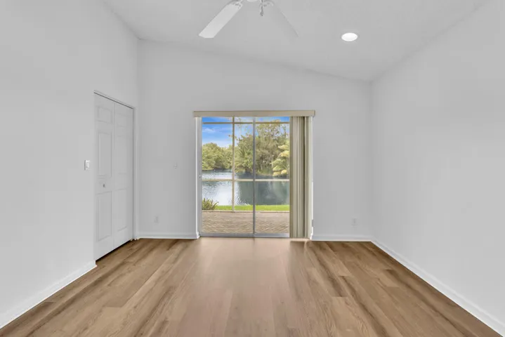 Primary Bedroom with vaulted ceilings, brand new luxury vinyl plank and freshly painted