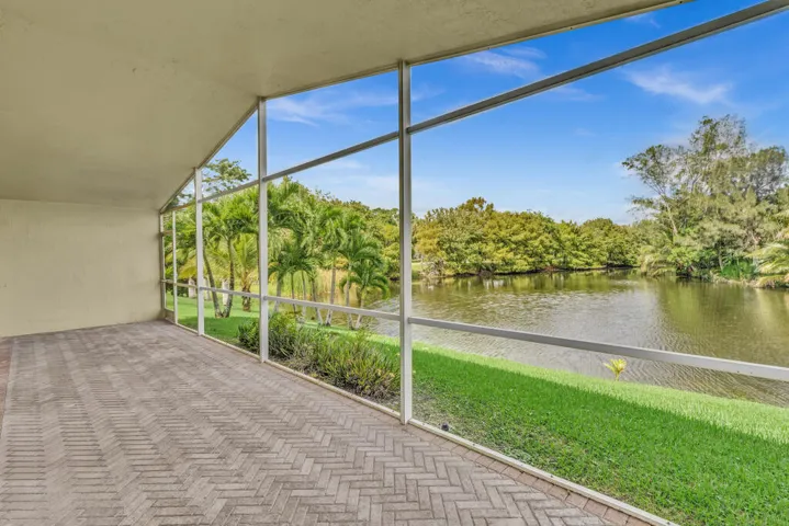 Oversized screened in patio with vaulted ceilings overlooking the water
