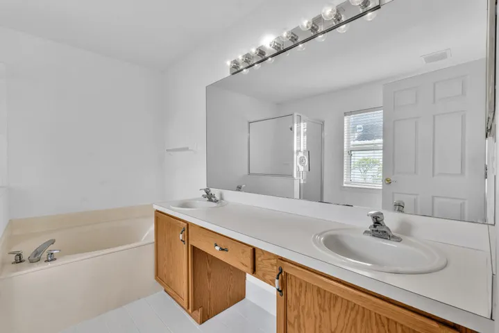 Primary Bathroom with Dual Vanity Sinks & Separate Shower & Roman Tub