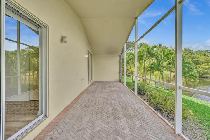 Oversized screened in patio with vaulted ceilings overlooking the water