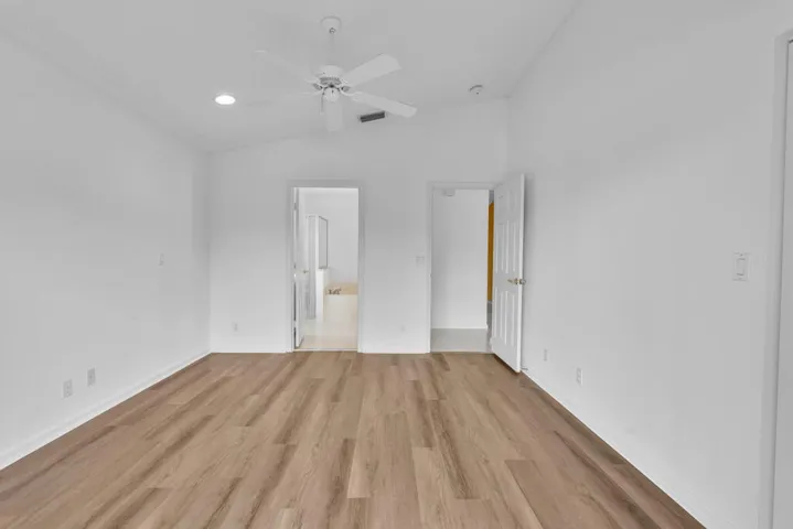 Primary Bedroom with vaulted ceilings, brand new luxury vinyl plank and freshly painted