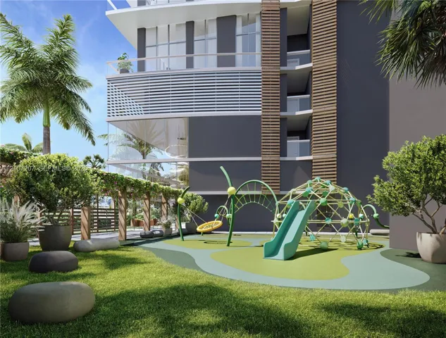 Outdoor recreational area featuring a structured play system with a slide, climbing dome, and rope swing, set within a landscaped space defined by a wooden pergola, lush greenery, and large stone accents
