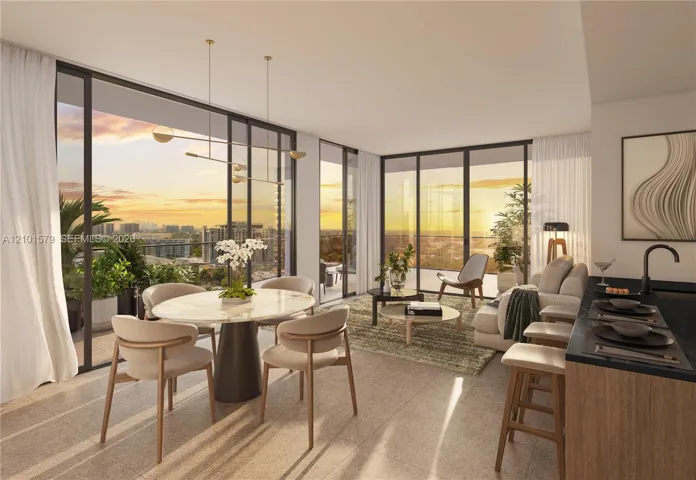 Floor-to-ceiling windows, open balcony access, neutral stone-finish flooring, modern linear pendant lighting, and kitchen with dark-toned cabinetry and matte black hardware