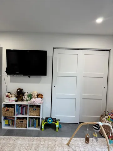 Sliding bypass closet doors with shaker-style panels and recessed lighting