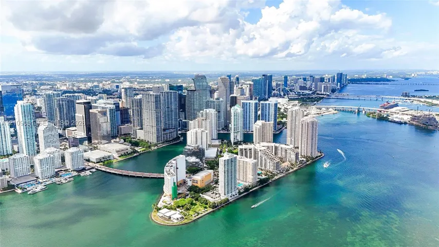Aerial perspective featuring high-density urban skyline, waterfront positioning, and deep-water access points