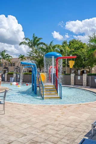 Splash pad featuring a central water feature, integrated stairs, and surround hardscaping