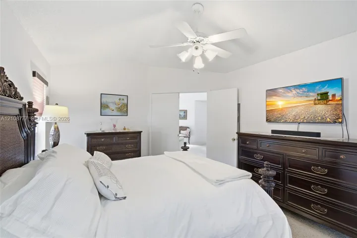 White vaulted ceilings featuring a central four-blade ceiling fan with integrated multi-light fixture