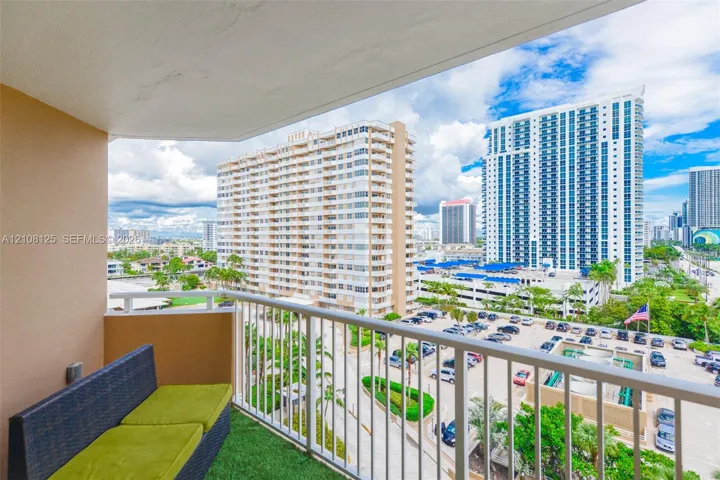 Private balcony featuring a white metal railing and a concrete floor