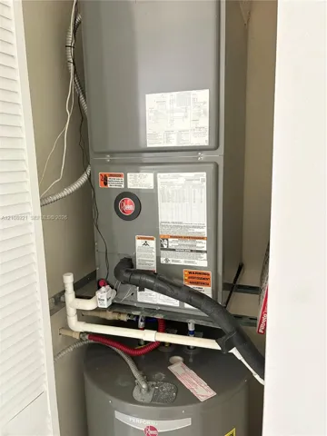 Utility closet containing a Rheem HVAC air handler unit and a Rheem water heater